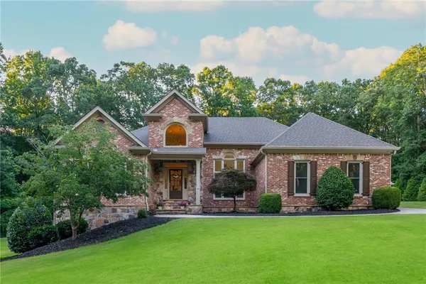 a front view of a house with a yard and porch