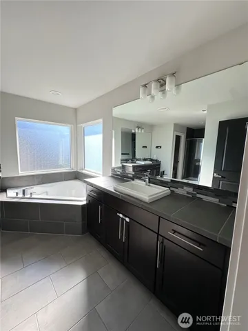 a large bathroom with a large tub and sink