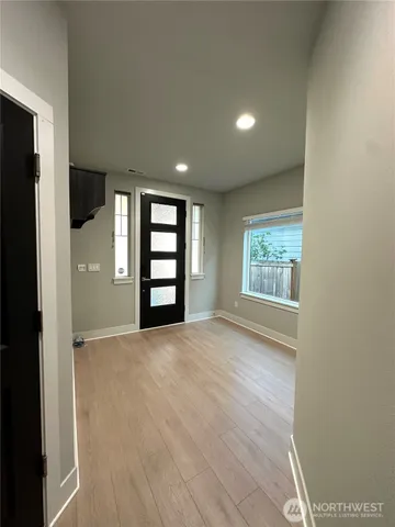an empty room with windows and closet