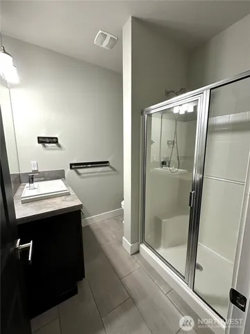 a view of bathroom with a shower and mirror
