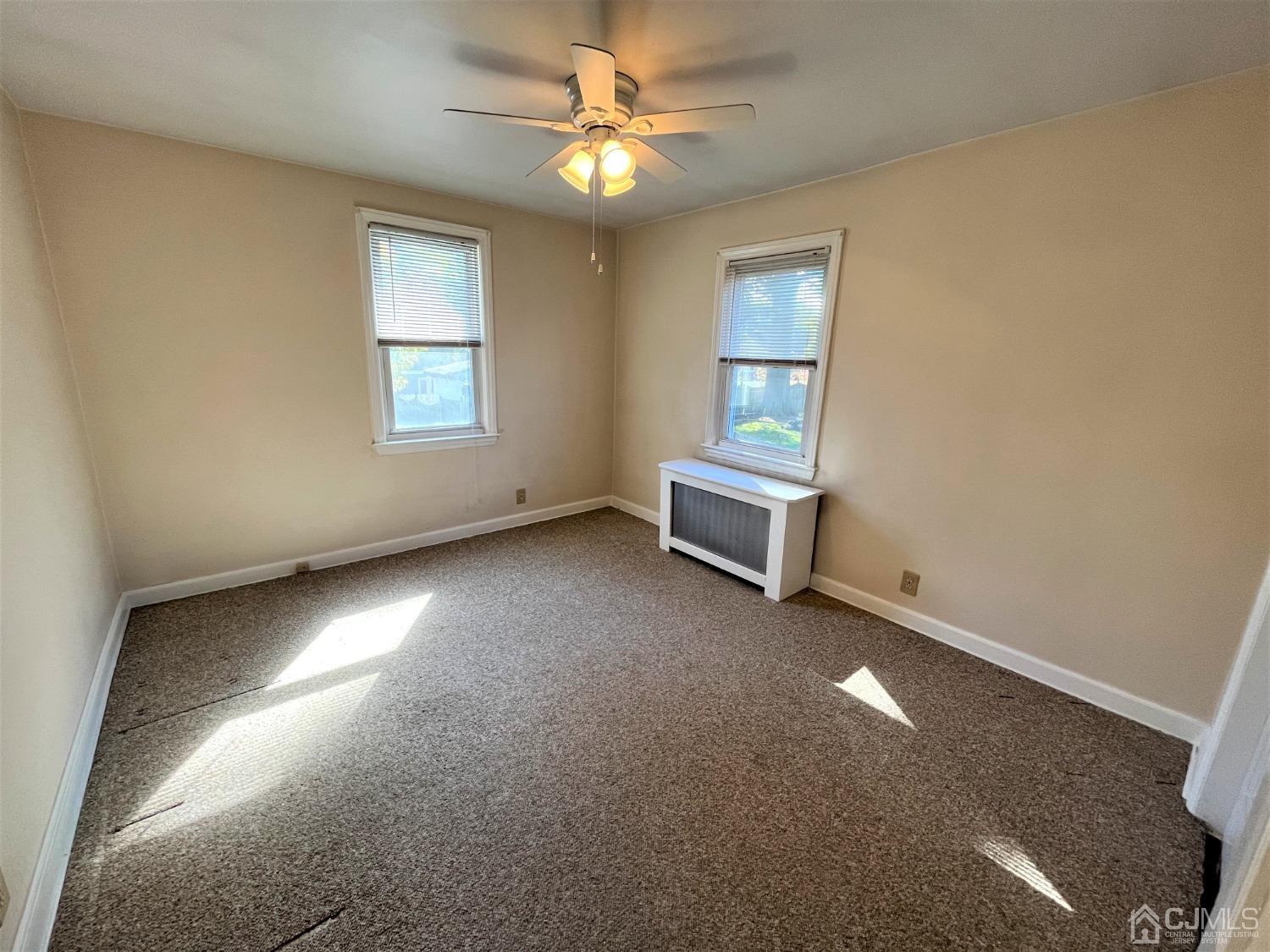 5 Outlook Avenue Colonia, NJ 07067 - Photo 8 of 21 an empty room with windows and fan