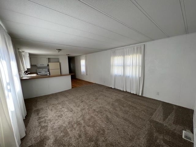 3349 F Road, Unit 14 Clifton, CO 81520 - Photo 5 of 10 a view of a livingroom with an empty space and a window