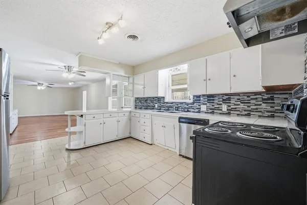 a kitchen that has a sink and a stove