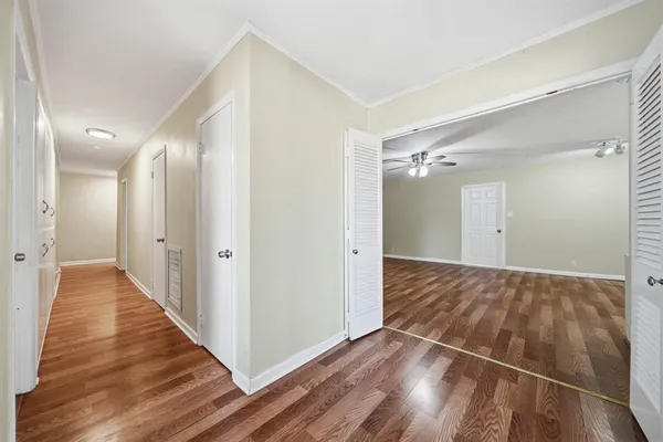 a view of a hallway with wooden floor