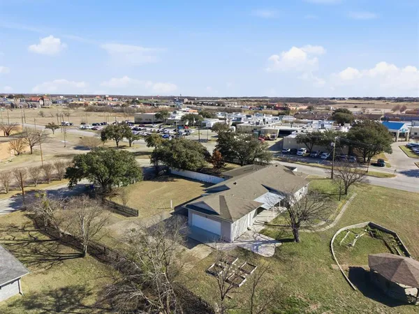 an aerial view of a residential houses with outdoor space
