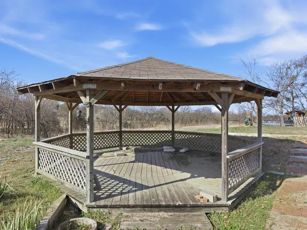 a view of a roof deck with chair and table