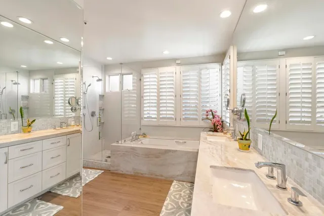 a large spacious bathroom with a large tub shower and sink