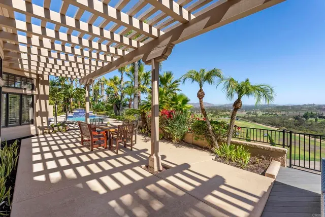a view of a chairs and table in patio with wooden fence
