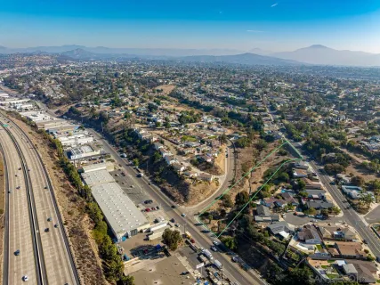 an aerial view of residential building and ocean