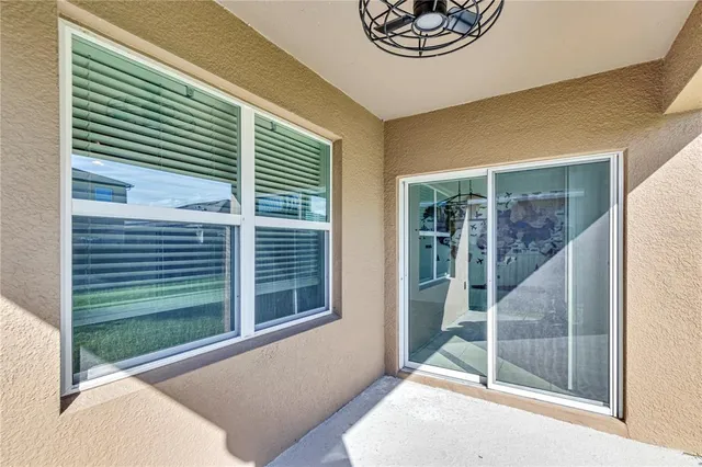 a view of a porch with a table and chairs