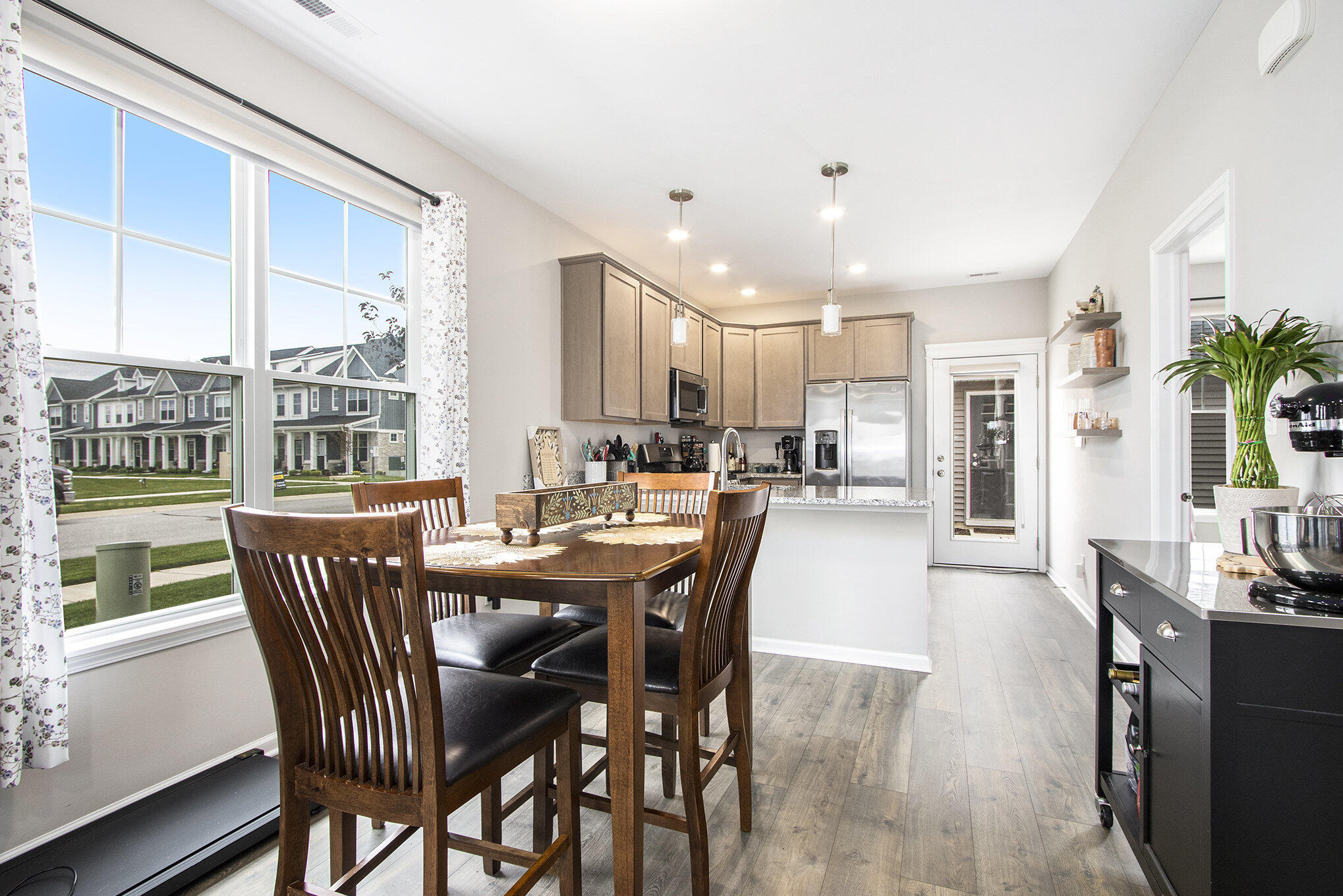 1053 East 117th Lane Crown Point, IN 46307 - Photo 7 of 23 a dining room with furniture a floor to ceiling window and wooden floor