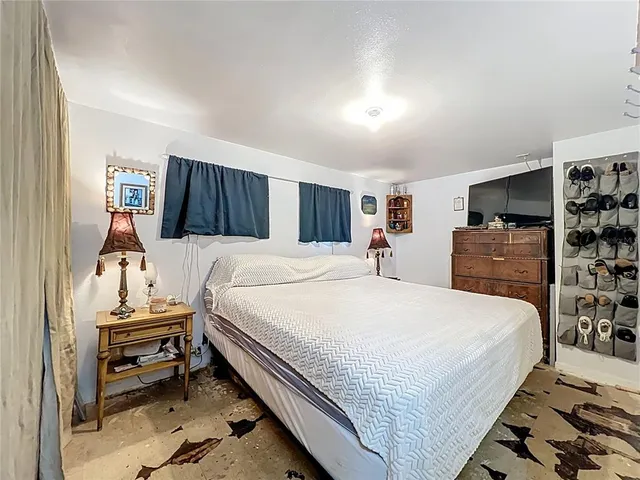 a bedroom with a bed and a night stand