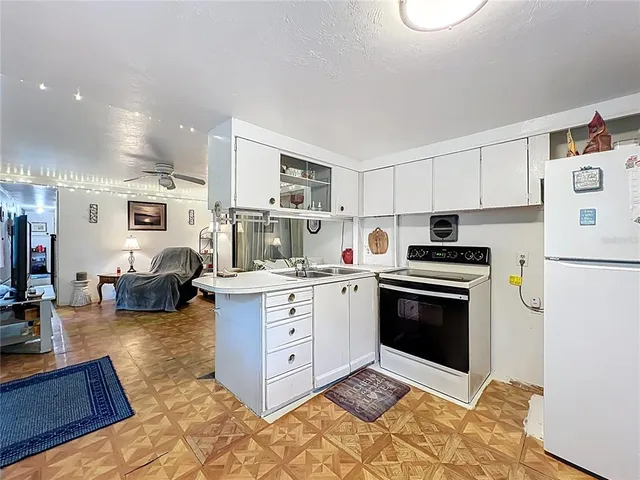 a kitchen with stainless steel appliances a stove a sink and a refrigerator