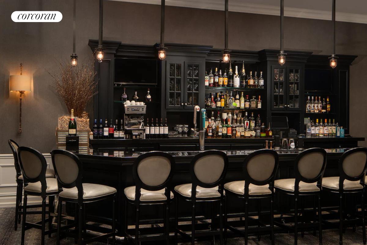 200 West 56th Street, Unit 904 Manhattan, NY 10019 - Photo 12 of 15 a kitchen with granite countertop a table chairs stove and cabinets