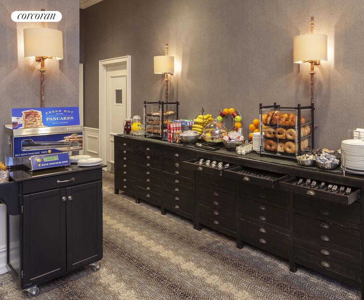 200 West 56th Street, Unit 904 Manhattan, NY 10019 - Photo 13 of 15 a kitchen with granite countertop stove and cabinets