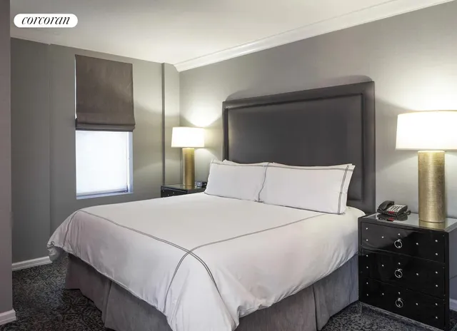 a bedroom with a bed and a lamp