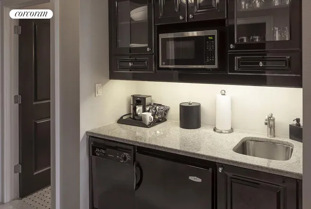 a kitchen with a sink and microwave