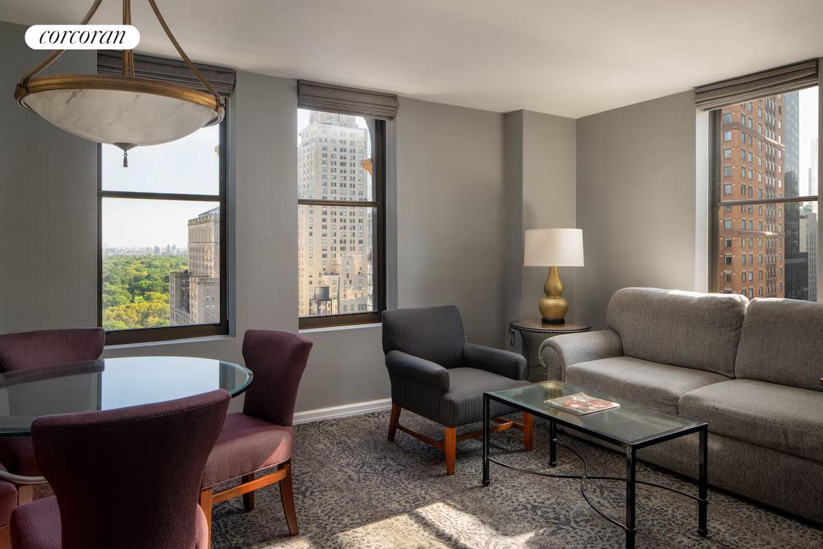 200 West 56th Street, Unit 904 Manhattan, NY 10019 - Photo 6 of 15 a living room with furniture and a window