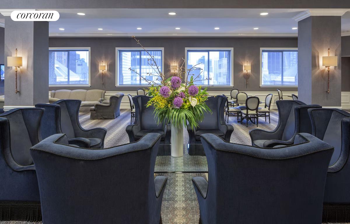 200 West 56th Street, Unit 904 Manhattan, NY 10019 - Photo 10 of 15 a living room with furniture and a potted plant