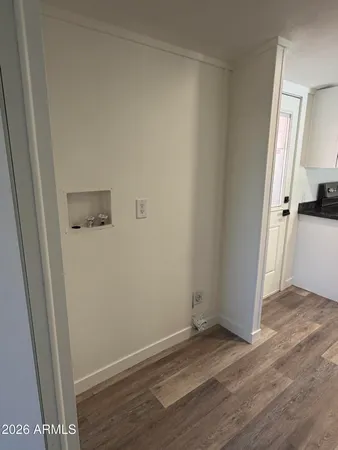 a view of a hallway with wooden floor