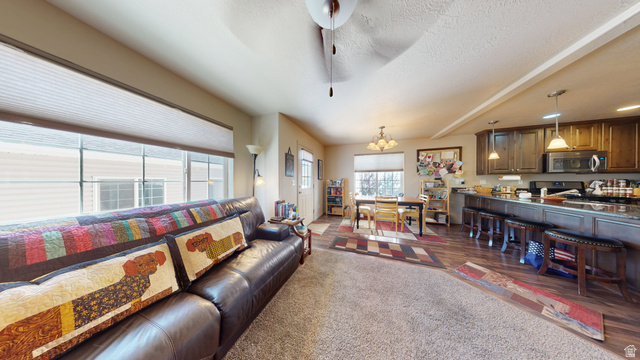1674 Eastridge Road Price, UT 84501 - Photo 11 of 34 Open concept living area featuring a kitchen with dark cabinetry, stainless steel appliances, and a breakfast bar