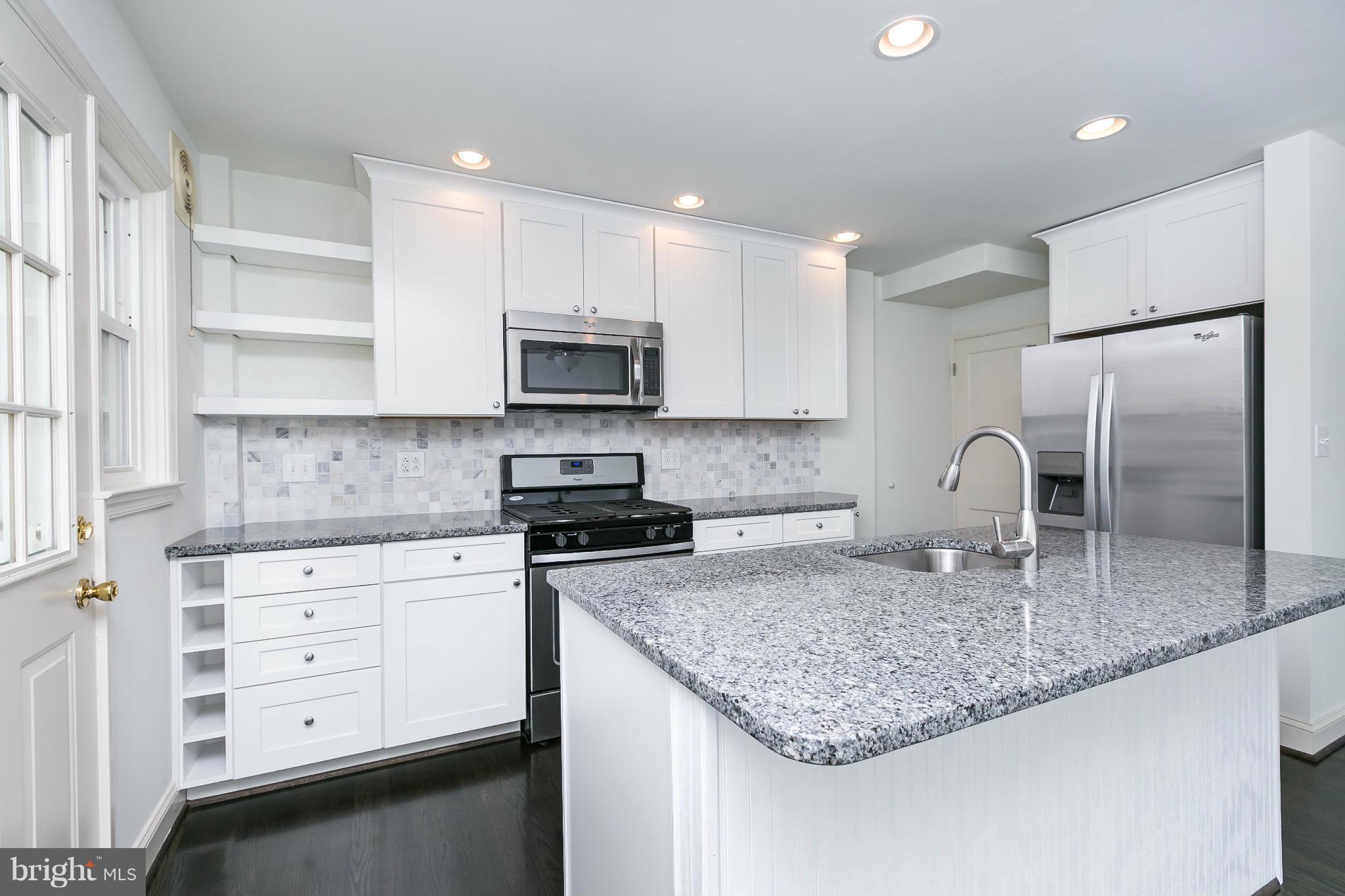 1636 Aberdeen Road Baltimore, MD 21286 - Photo 12 of 30 a kitchen with kitchen island granite countertop a sink stove and refrigerator