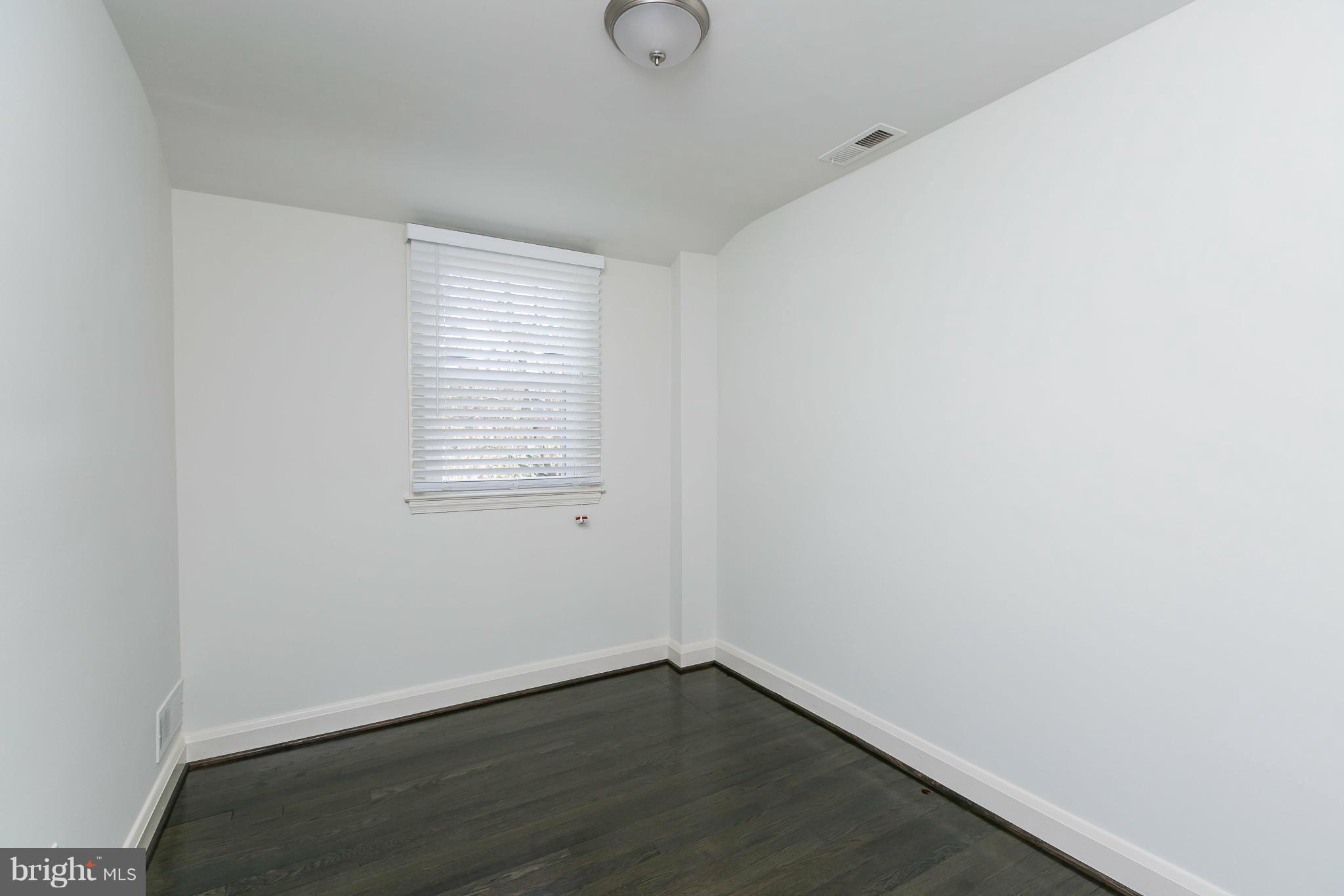1636 Aberdeen Road Baltimore, MD 21286 - Photo 15 of 30 a view of an empty room with wooden floor and a window
