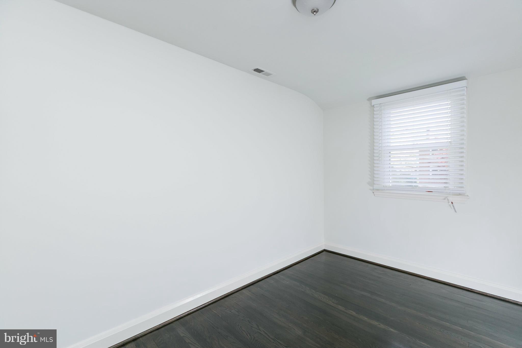 1636 Aberdeen Road Baltimore, MD 21286 - Photo 18 of 30 a view of an empty room with wooden floor and a window