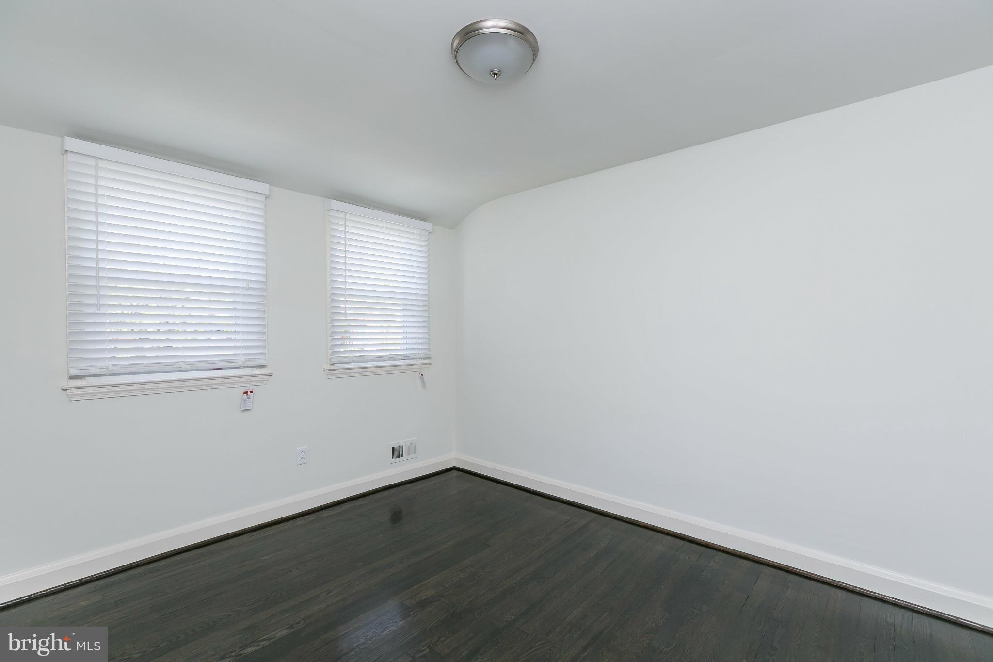 1636 Aberdeen Road Baltimore, MD 21286 - Photo 19 of 30 an empty room with wooden floor and windows