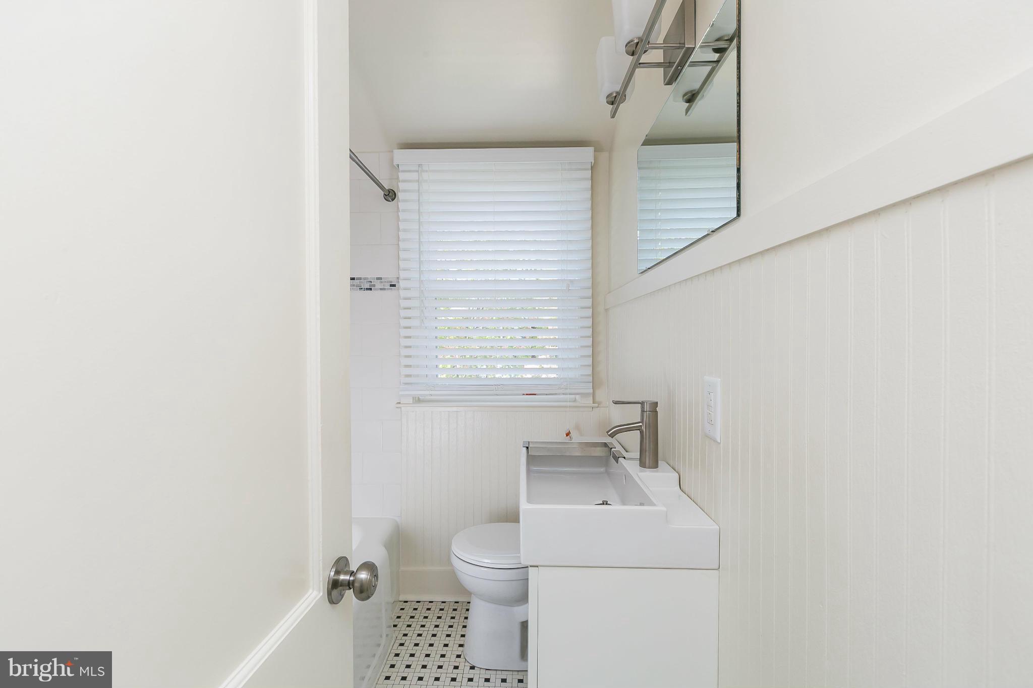 1636 Aberdeen Road Baltimore, MD 21286 - Photo 22 of 30 a bathroom with a sink a toilet and a window