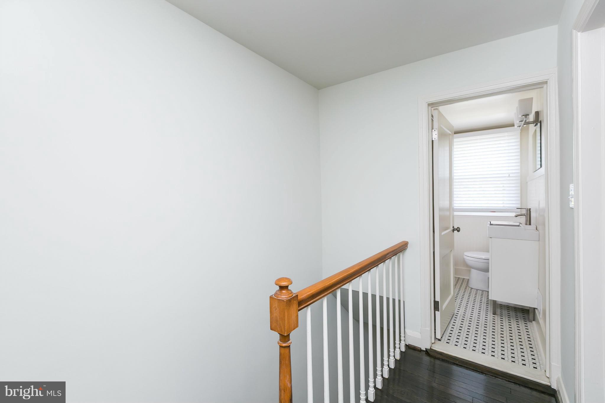 1636 Aberdeen Road Baltimore, MD 21286 - Photo 24 of 30 a view of a hallway with wooden floor and a bathroom