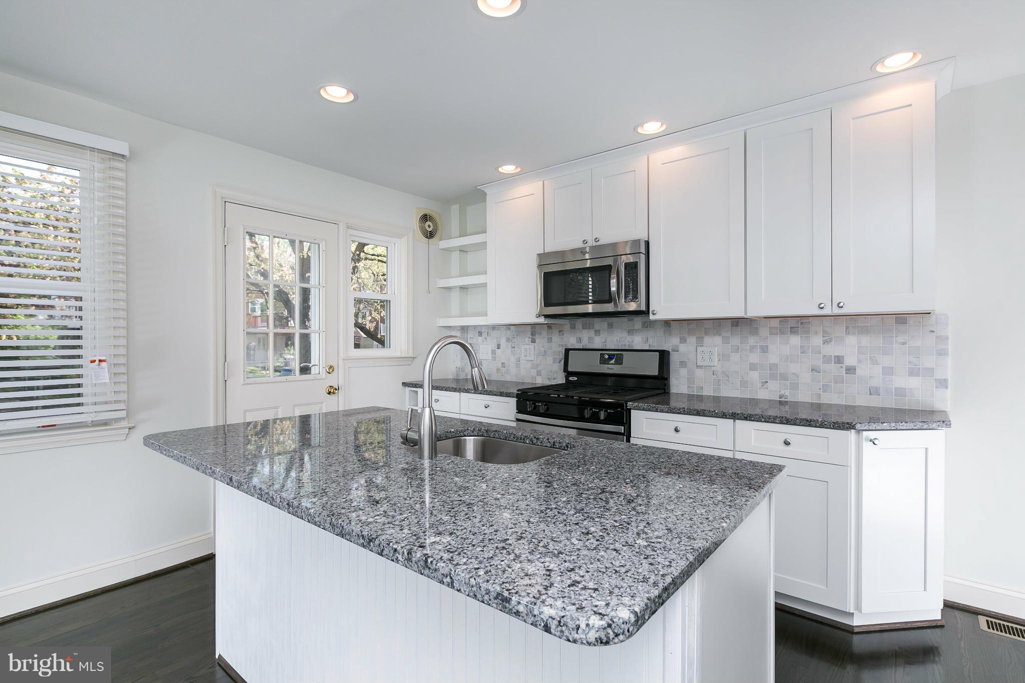 1636 Aberdeen Road Baltimore, MD 21286 - Photo 9 of 30 a kitchen with granite countertop a sink a counter top space appliances and cabinets
