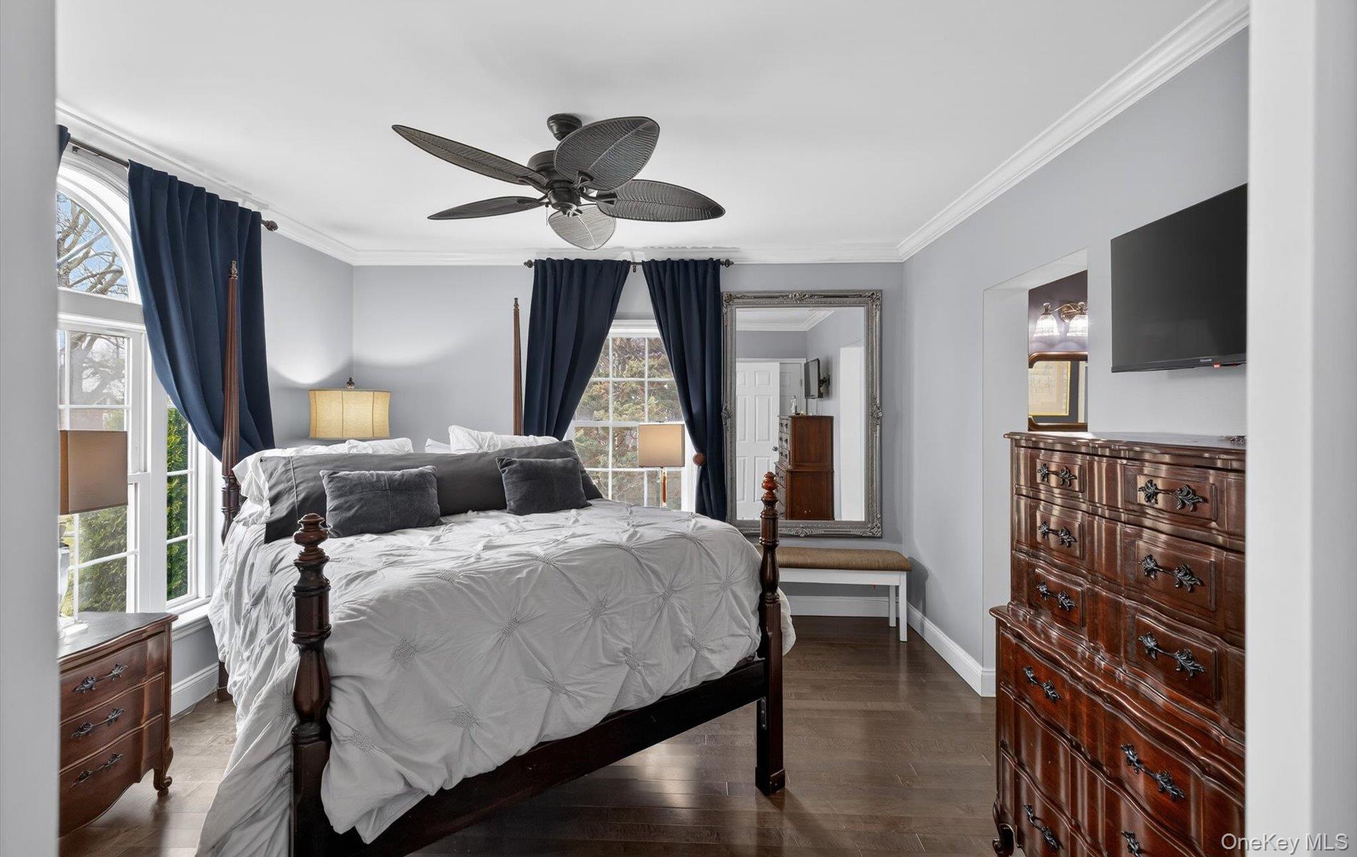108 Awixa Avenue Bay Shore, NY 11706 - Photo 16 of 47 Bedroom featuring crown molding, dark wood-type flooring, and a ceiling fan
