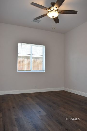1319 South Farragut Street Ridgecrest, CA 93555 - Photo 19 of 33 a view of wooden floor and chandelier fan in a room