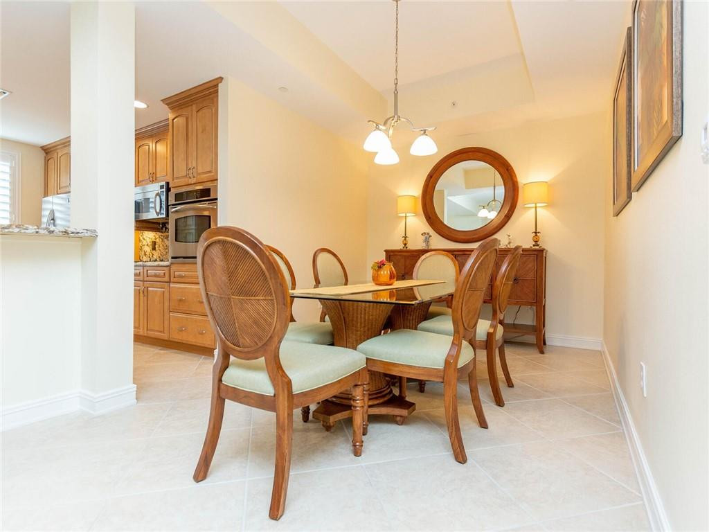 16101 Emerald Estates Drive, Unit 252 Weston, FL 33331 - Photo 11 of 51 a view of a dining room with furniture and a chandelier