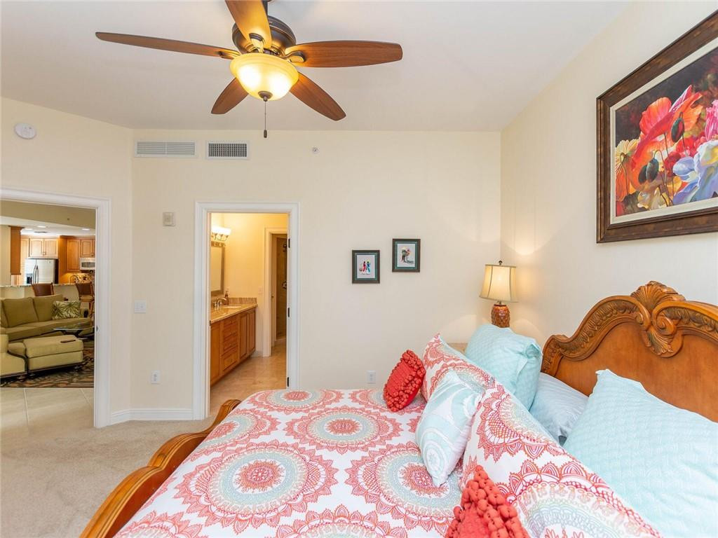 16101 Emerald Estates Drive, Unit 252 Weston, FL 33331 - Photo 17 of 51 a bedroom with a bed and a chandelier