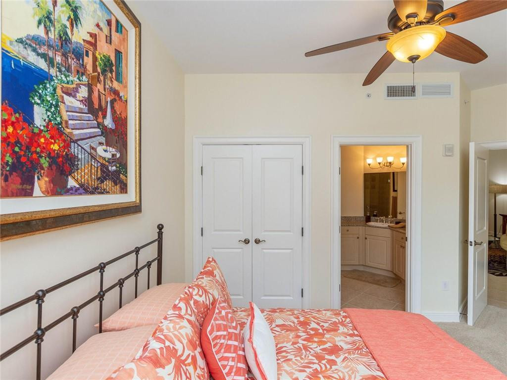 16101 Emerald Estates Drive, Unit 252 Weston, FL 33331 - Photo 28 of 51 a bedroom with a bed and a painting on the wall