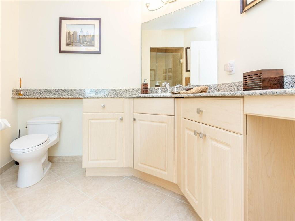 16101 Emerald Estates Drive, Unit 252 Weston, FL 33331 - Photo 29 of 51 a bathroom with a granite countertop sink and a mirror
