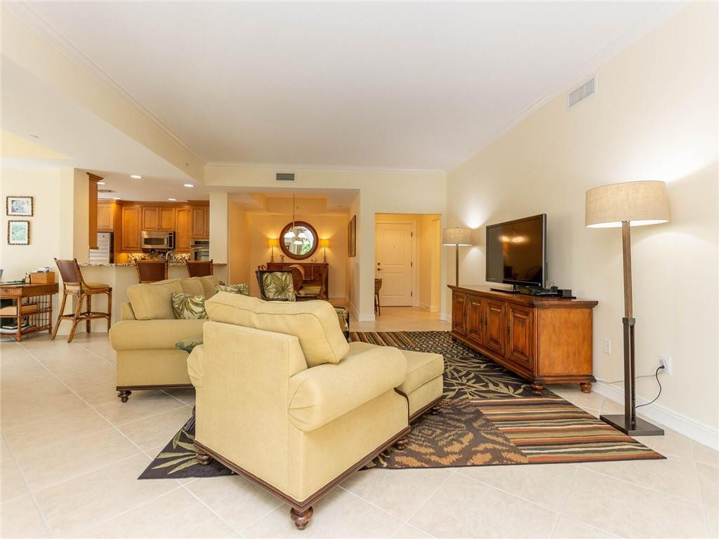 16101 Emerald Estates Drive, Unit 252 Weston, FL 33331 - Photo 3 of 51 a living room with furniture and a flat screen tv