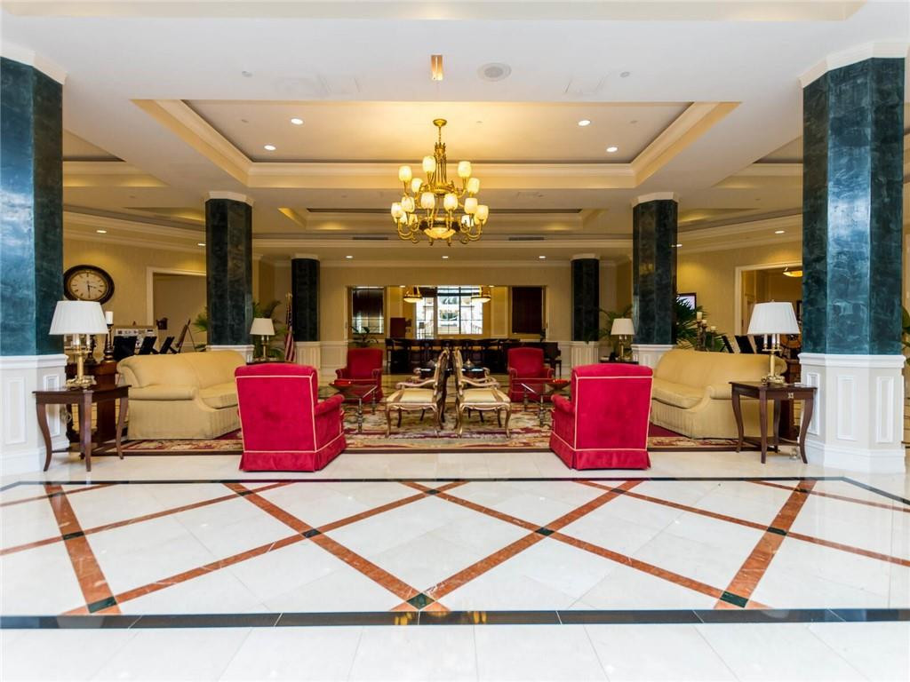 16101 Emerald Estates Drive, Unit 252 Weston, FL 33331 - Photo 38 of 51 a living room with furniture and a chandelier