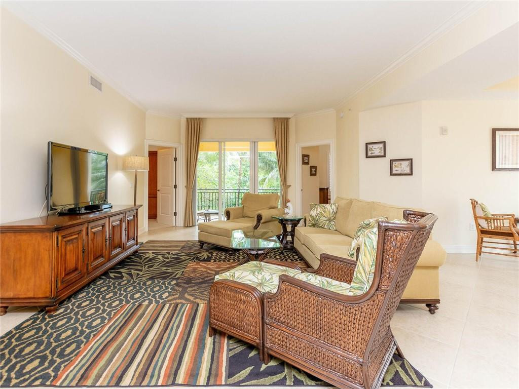 16101 Emerald Estates Drive, Unit 252 Weston, FL 33331 - Photo 4 of 51 a living room with furniture a flat screen tv and a large window