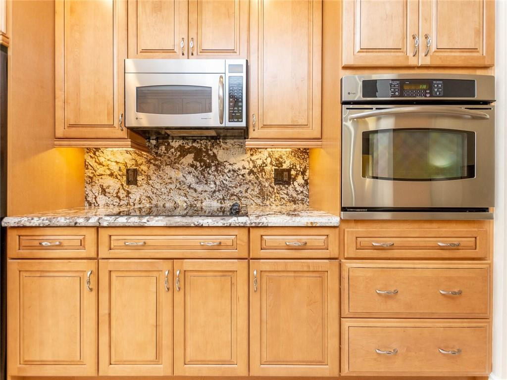 16101 Emerald Estates Drive, Unit 252 Weston, FL 33331 - Photo 8 of 51 a kitchen with granite countertop white cabinets stainless steel appliances and a sink