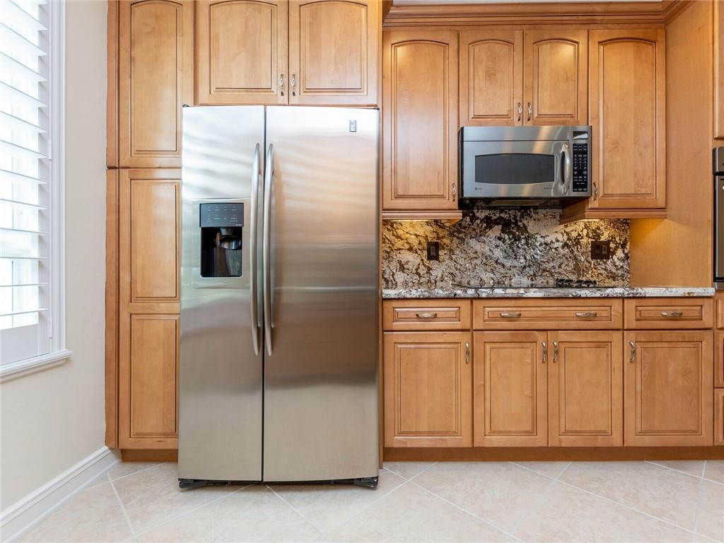 16101 Emerald Estates Drive, Unit 252 Weston, FL 33331 - Photo 9 of 51 a kitchen with stainless steel appliances granite countertop a refrigerator and a stove