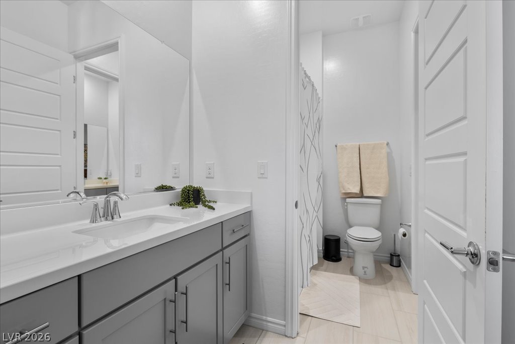 20 Charlotte Ridge Place Henderson, NV 89011 - Photo 24 of 33 A well-lit bathroom features a modern vanity and clean design elements.