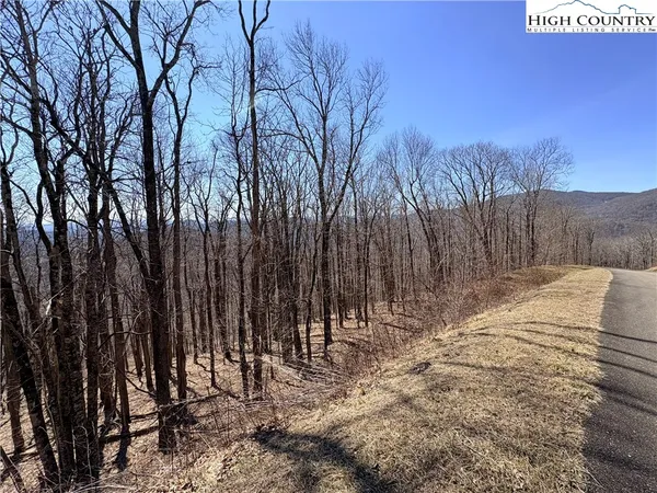 a view of wooden fence next to a road