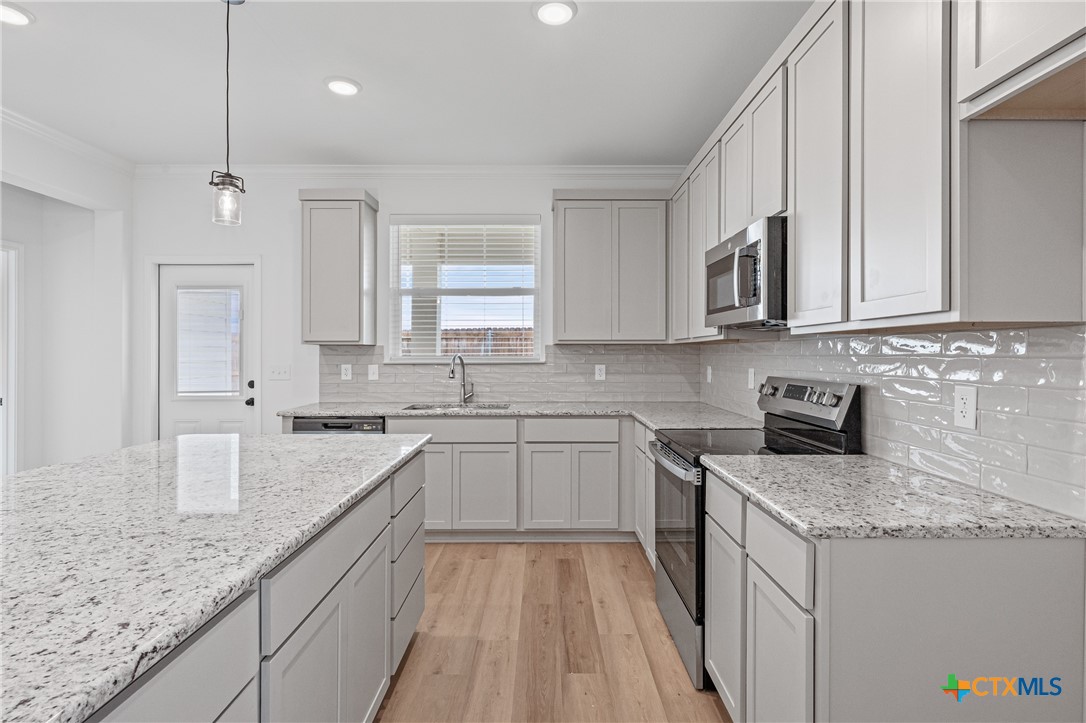 8019 Pineridge Way Temple, TX 76502 - Photo 15 of 32 a kitchen with granite countertop cabinets stainless steel appliances a sink and a counter top space