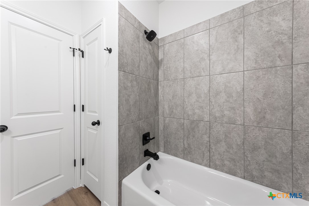8019 Pineridge Way Temple, TX 76502 - Photo 21 of 32 a bathroom with a white bath tub and a shower