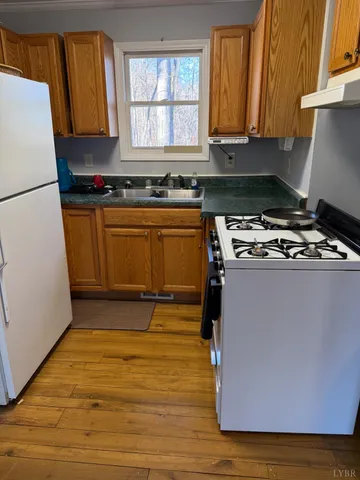 a kitchen with granite countertop a stove and a refrigerator