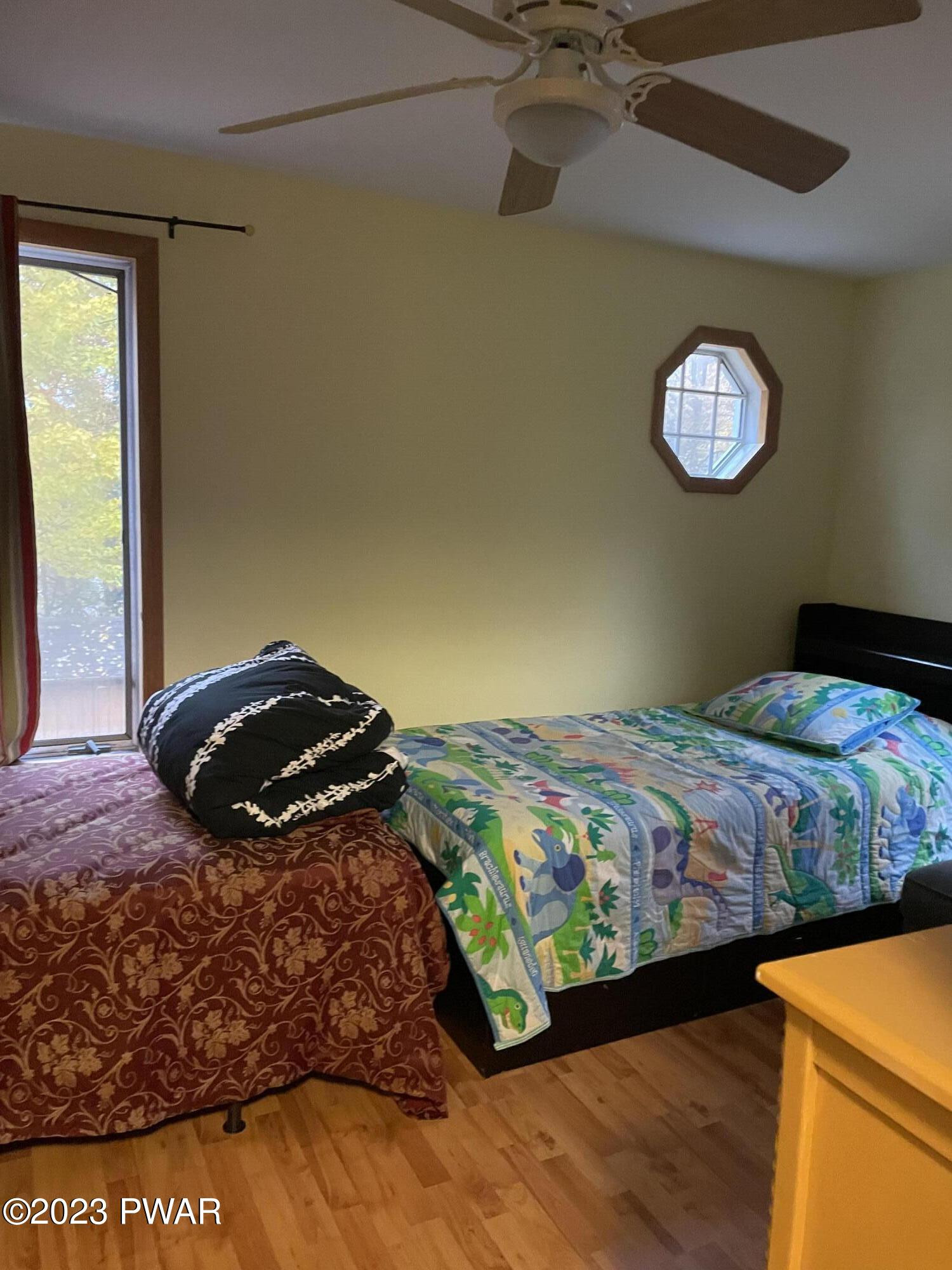 112 Stamford Road Dingmans Ferry, PA 18328 - Photo 16 of 26 a bedroom with a bed and a chandelier