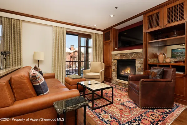 a living room with furniture fireplace and flat screen tv